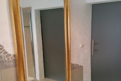 large mirror opposite the shower with sliding glass door